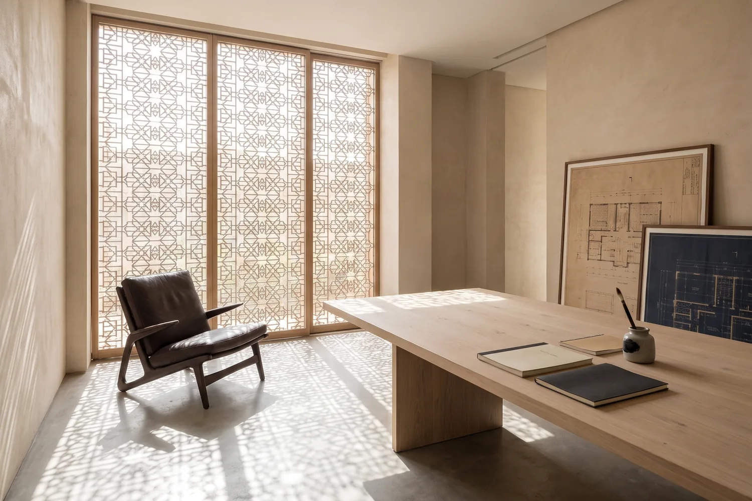 A calm, light-filled executive interior with a single chair and a long timber table